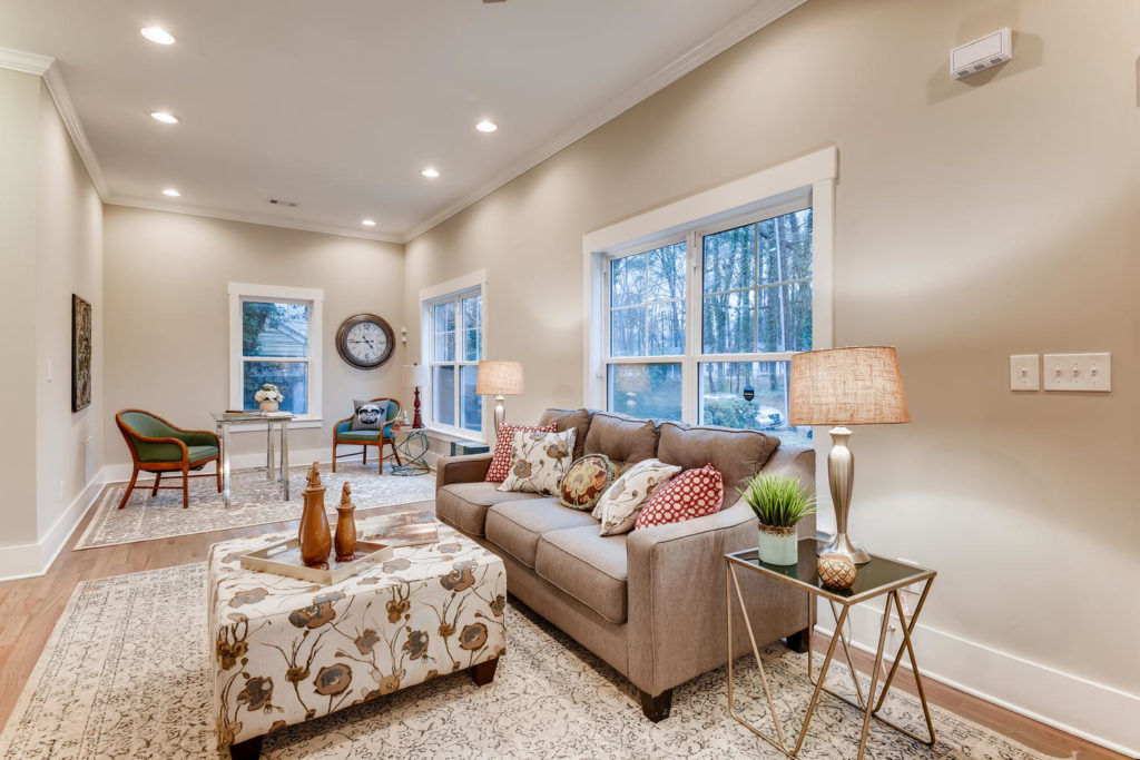 real estate image of living room with couch and ottoman