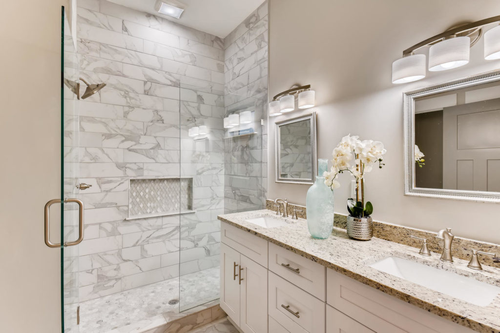real estate image of bathroom with gray and white tiled shower