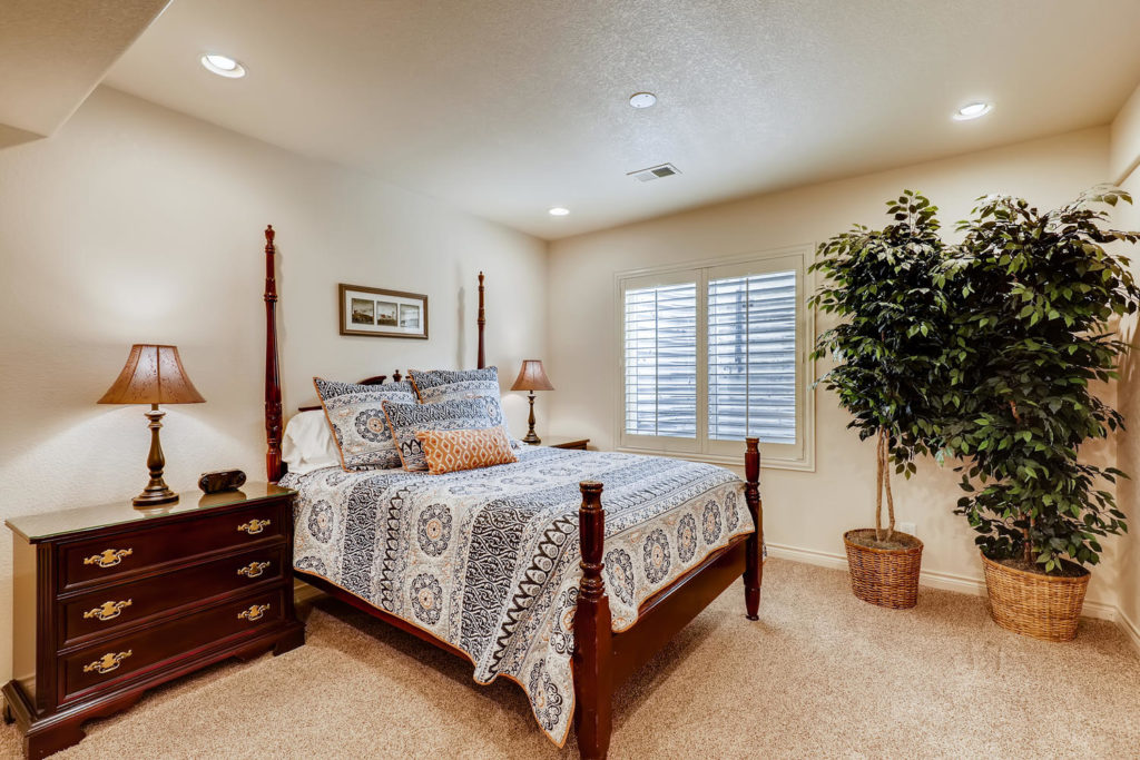 real estate image of a guest bedroom with plants