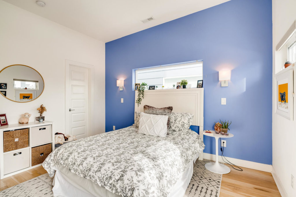 real estate image of bedroom with blue wall
