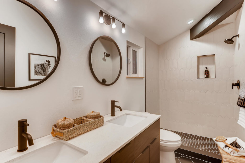 real estate image of bathroom with round mirrors