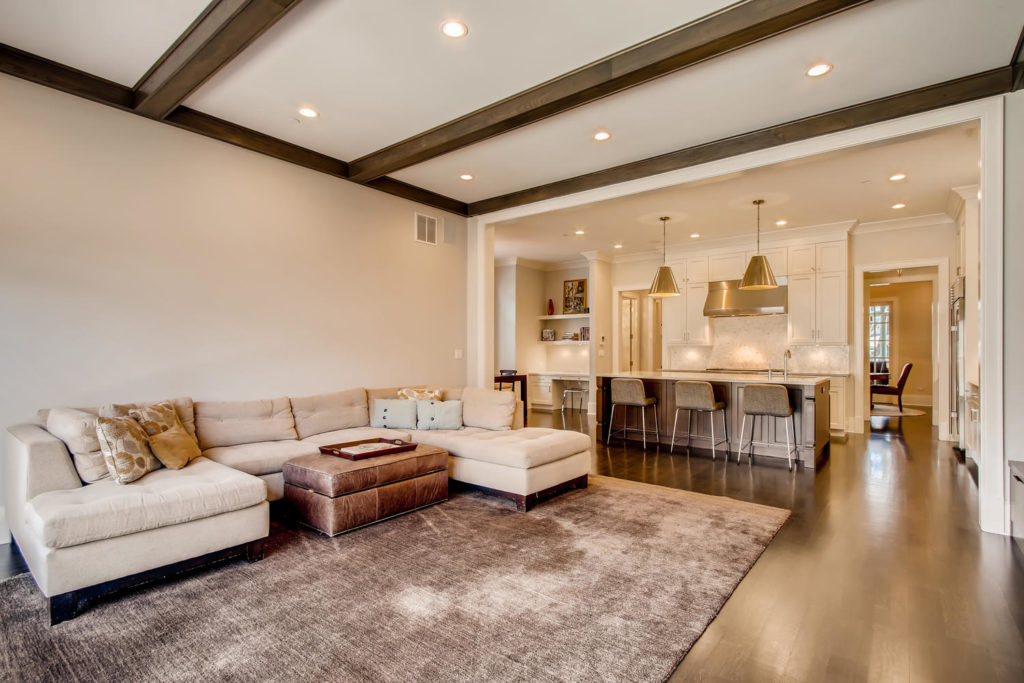 living room with sectional and kitchen