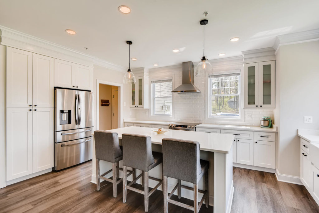 white kitchen with larder cupboard and range hood