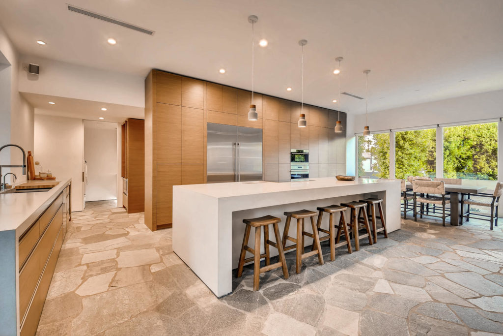 large kitchen with larder cupboard and stone floor