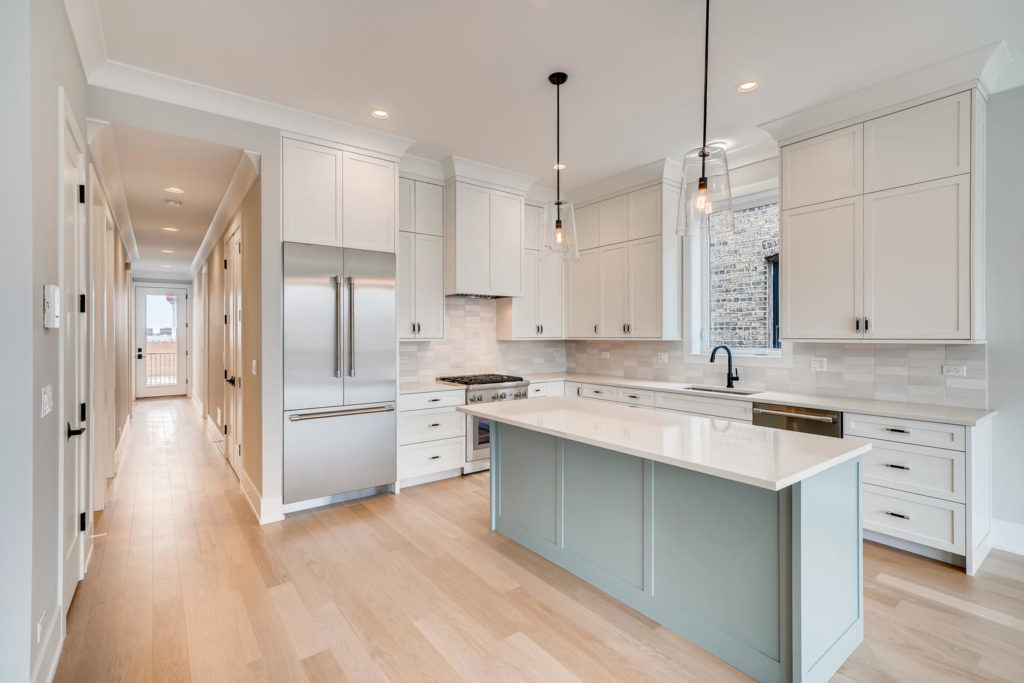 White kitchen with sage green island