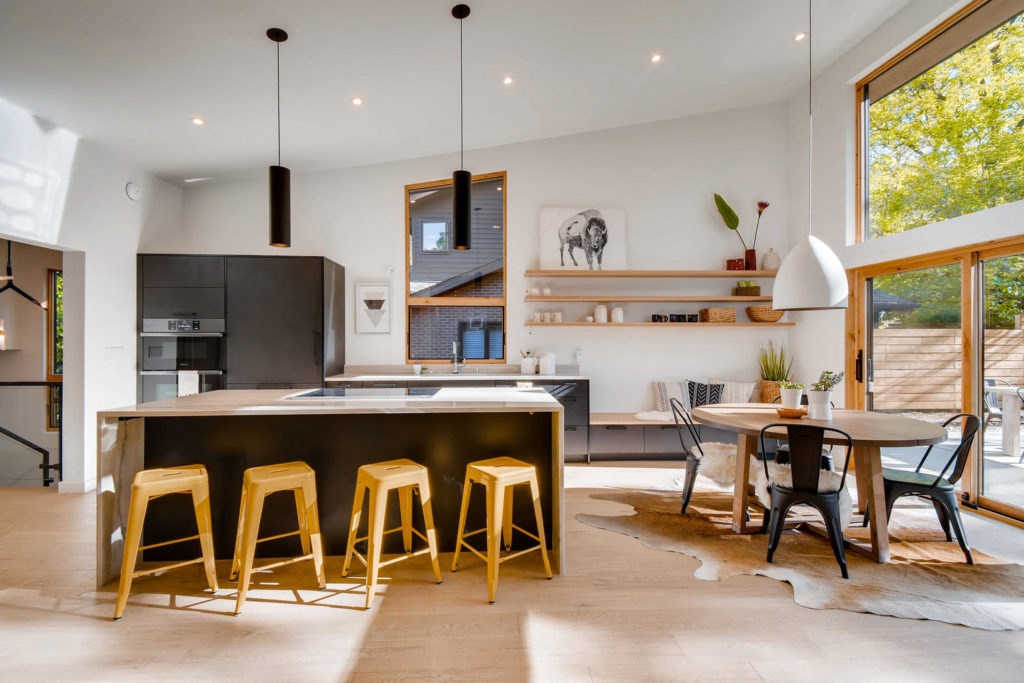 Kitchen with black cabinets and hidden fridge