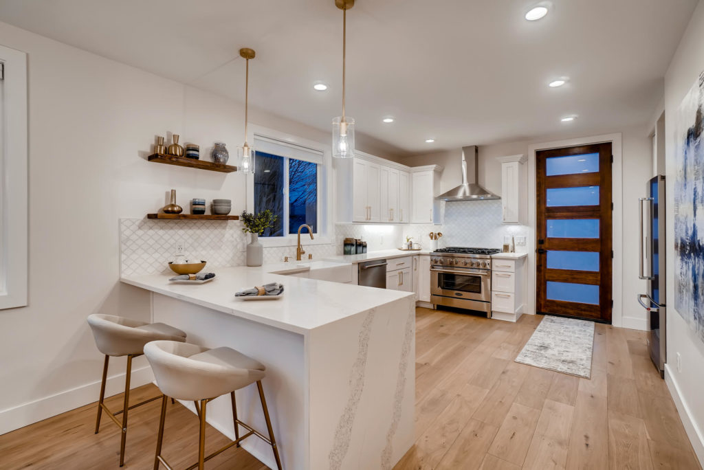 kitchen with marble waterfall island and open shelves