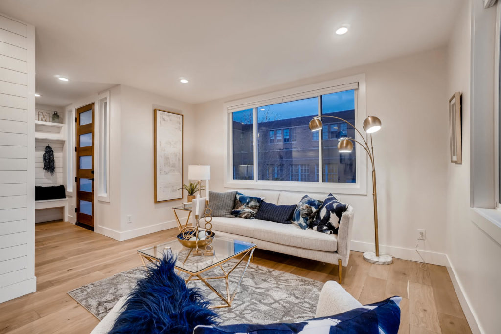 Front entry room and living room with white couch