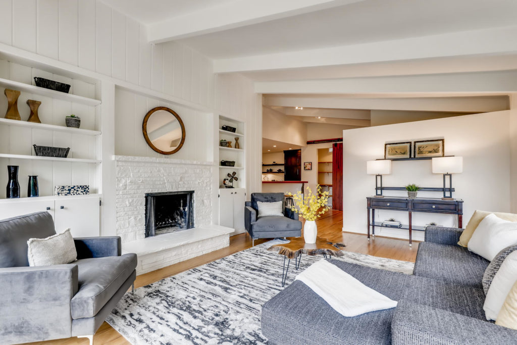 Living room with white fireplace