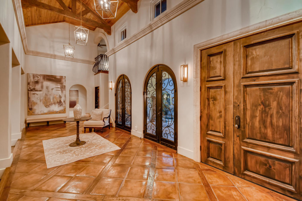 Foyer with clay tile floors and wood beams