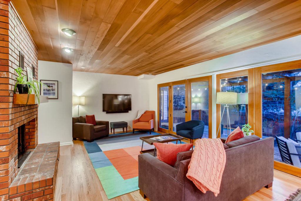 Colorful living room with wood panel ceilings