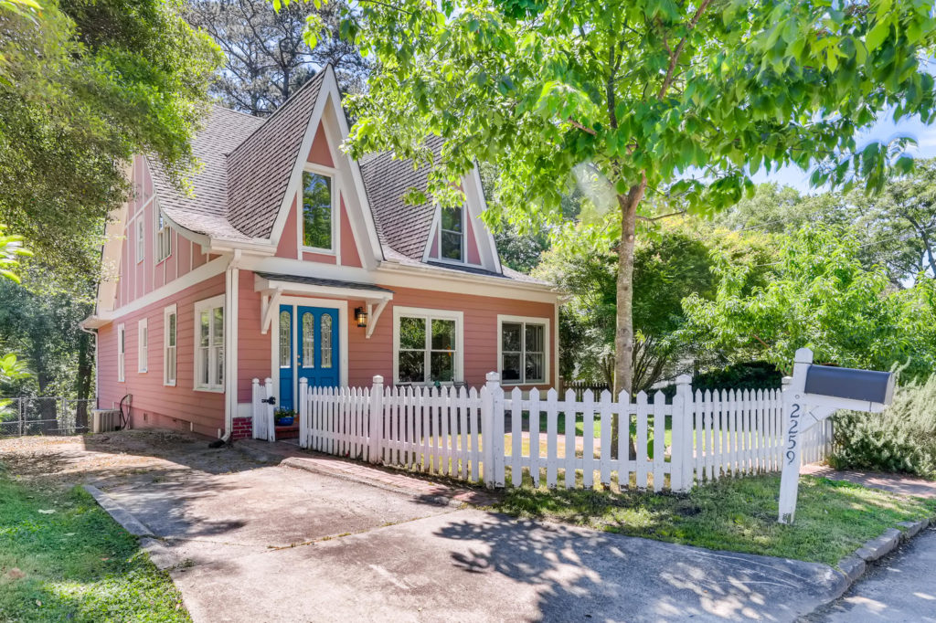 Atlanta home with pink siding and a blue door