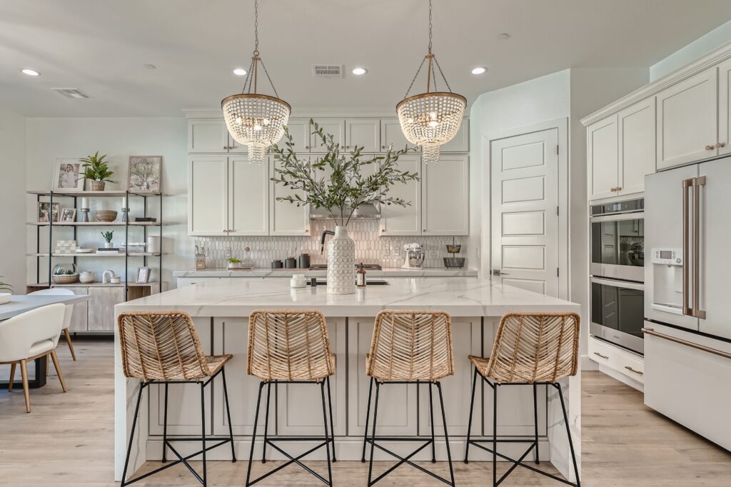 A kitchen with bright white cabinetry and a wood floor
