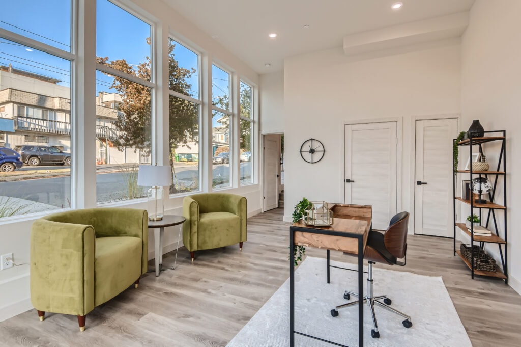 Bright green chairs accent a neutral room